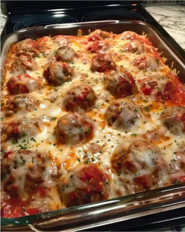 Delicious dump and bake meatball casserole topped with cheese and herbs