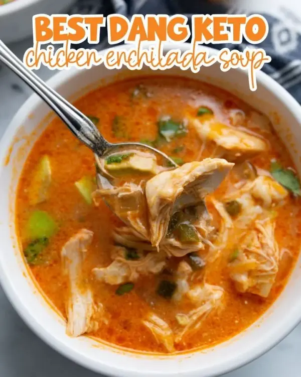 Bowl of Keto Chicken Enchilada Soup topped with cheese and cilantro