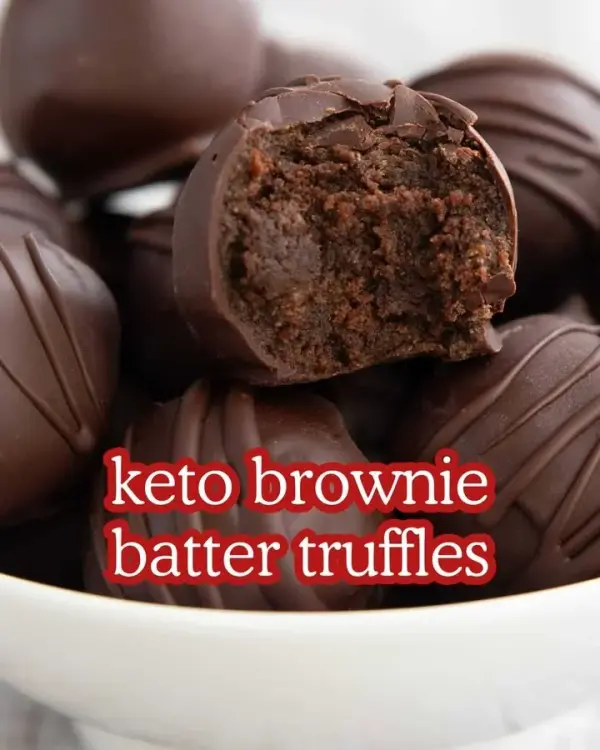 Delicious Keto Brownie Truffles on a plate garnished with cocoa powder.