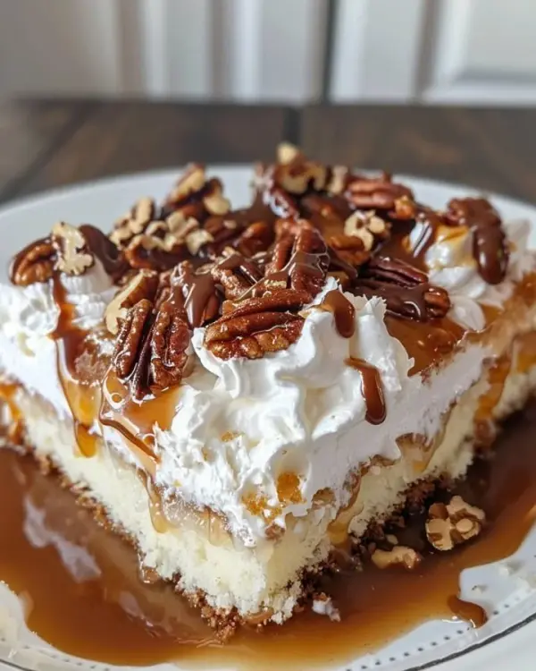 Delicious Butter Pecan Praline Poke Cake with nuts and praline topping