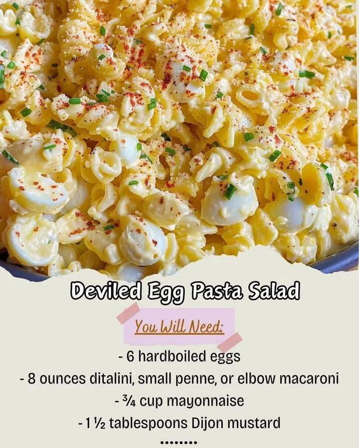 Bowl of deviled egg pasta salad topped with paprika and herbs