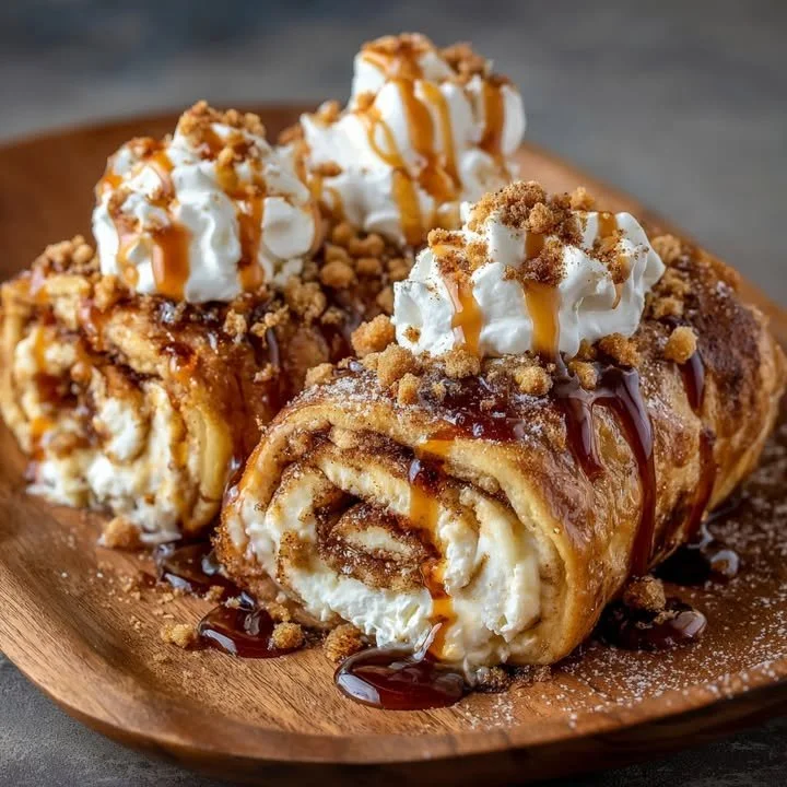 Cinnamon Roll Cheesecake Chimichangas served on a plate with cinnamon drizzle.