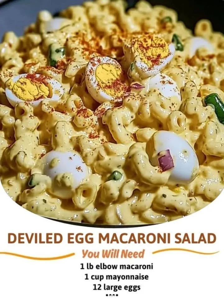 Bowl of deviled egg macaroni salad topped with herbs and spices