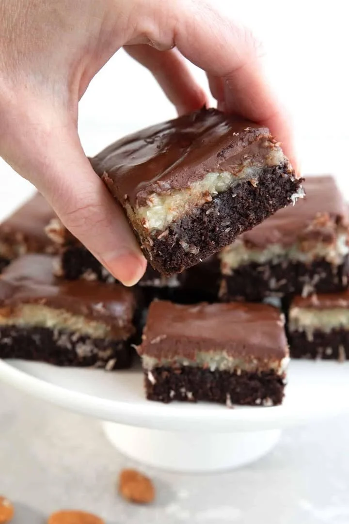 Delicious Keto Almond Joy Brownies topped with coconut and almonds