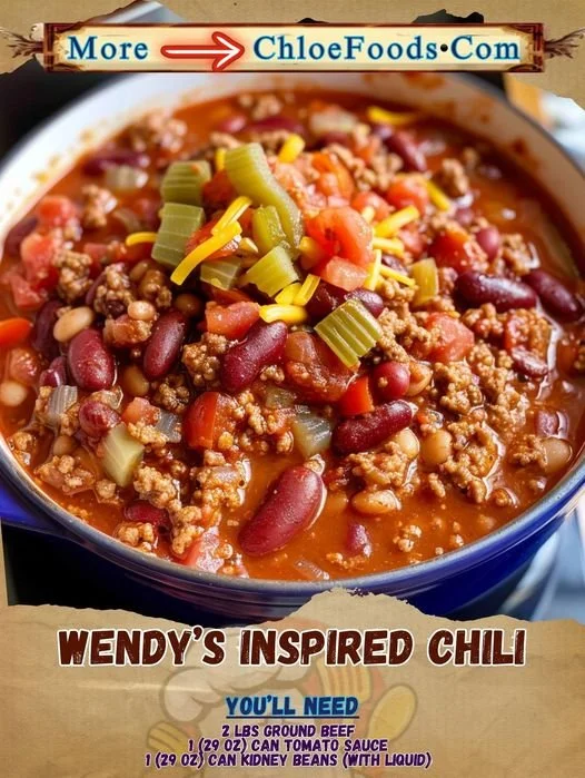 Bowl of Wendy's inspired chili topped with cheese and green onions