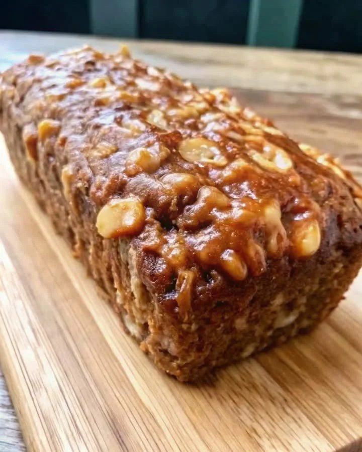 Freshly baked Apple Cinnamon Breakfast Loaf on a wooden table.