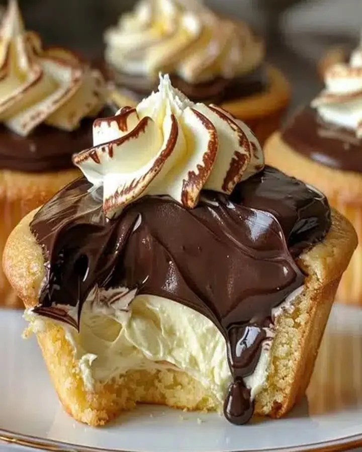 Boston Cream Pie Cupcakes topped with chocolate ganache and vanilla cream filling