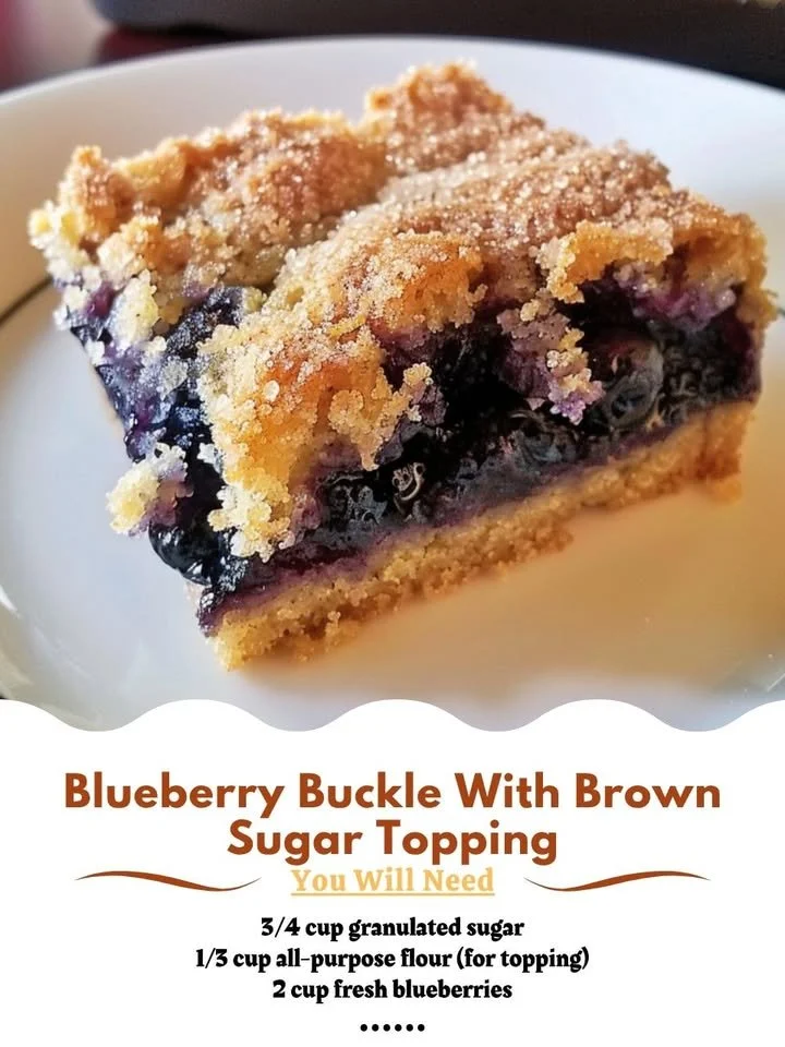 Blueberry buckle dessert with brown sugar topping on a white plate