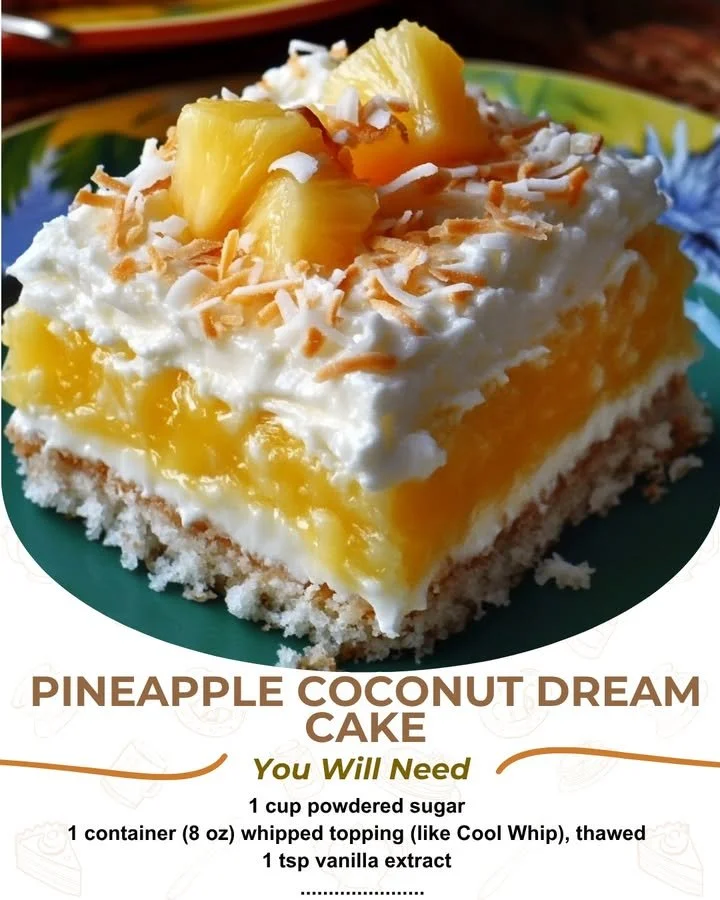 Pineapple Coconut Dream Cake topped with cream and coconut flakes