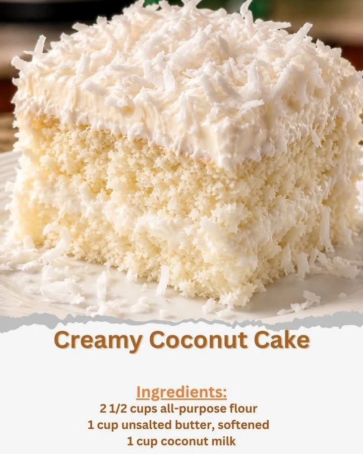Sliced creamy coconut cake topped with coconut flakes and frosting.