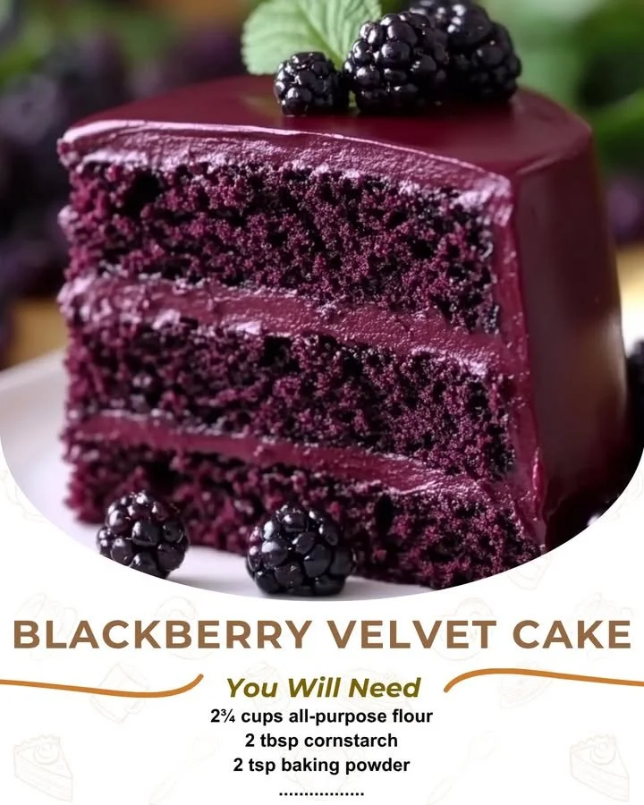 Slice of Blackberry Velvet Cake with vibrant blackberry topping on a plate